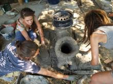 The beginnings of the community rocketstove, complete with a wheel hub
